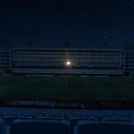 En la oscuridad, el palco de Maradona iluminado.